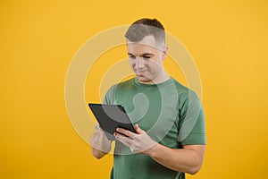 Amazed happy man using digital tablet looking shocked about social media news, astonished man shopper consumer surprised excited