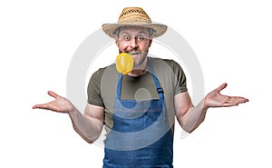 amazed man in apron and hat bite sweet pepper vegetable isolated on white