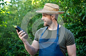 amazed man greengrocer in straw hat with eggplant vegetable