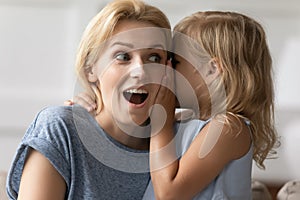 Amazed mother hears incredible news from little daughter closeup image