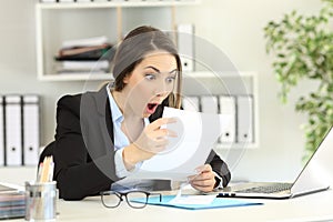 Amazed office worker reading a letter
