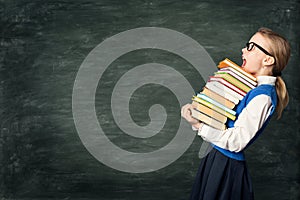 Amazed School Girl Holding Many Books, Astonished Strong Child Side View over Blackboard photo