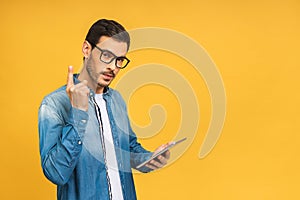 Amazed serious bearded man using digital tablet looking shocked about social media news, astonished man shopper consumer surprised