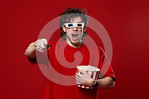 amazed shocked man in 3d glasses using remote controller