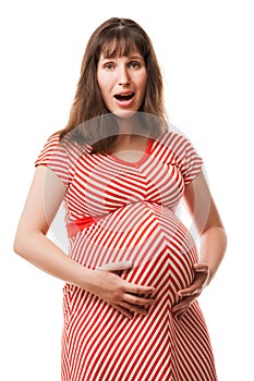 Amazed or surprised pregnant woman touching or bonding her abdomen