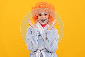 amazed teen girl in fancy orange wig hair wear home bathrobe, amazement