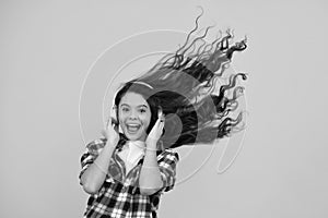Amazed teenager. Child listening music with headphones. Girl listening songs via wireless earphones. Headset device