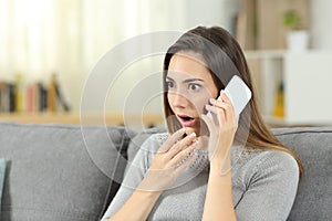 Amazed woman calling on phone