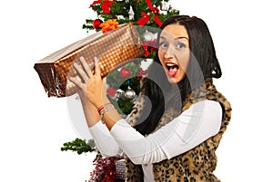 Amazed woman with Christmas present