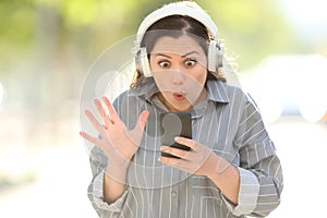 Amazed woman finding music on smart phone