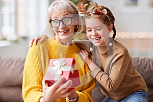 Amazed woman getting Christmas present from child