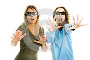 Amazed woman and girl in cinema wearing 3D glasses experiencing 5D cinema effect - scared watching performance - gestures of