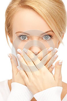 Amazed woman with hand over mouth