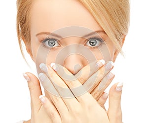 Amazed woman with hand over mouth
