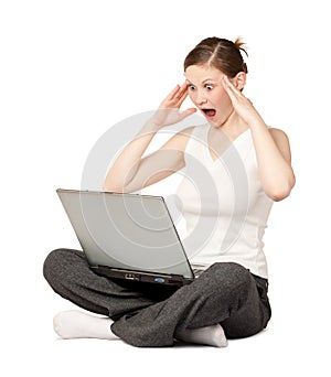 Amazed woman with laptop