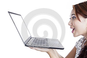 Amazed woman with laptop computer