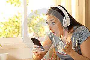 Amazed woman listening music finding offer