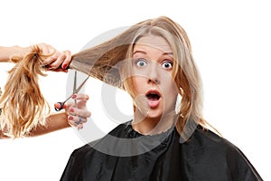 Amazed woman with long hair and scissors