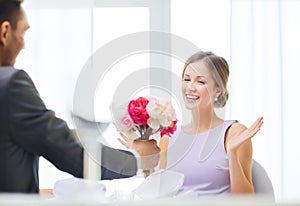 Amazed woman recieving bouquet of flowers