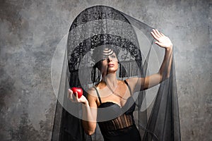 Amazed woman at russian traditional cap hat kokoshnik holding red apple