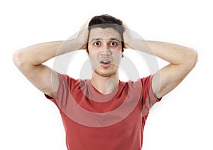 Amazed young man hand holding head