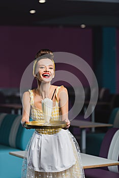 amazed young pin up waitress holding