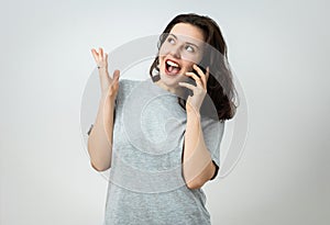 Amazed young woman on the phone