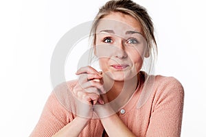 Amazed young woman touching both hands for reassurance