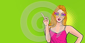 Amazed young woman wow in glasses pointing somthing