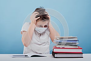 Amazement boy with medical mask looking at books,