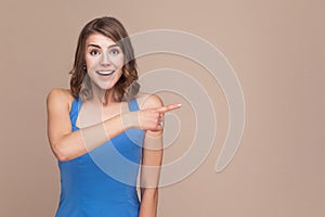 Amazement businesswoman pointing finger at copy space with shock