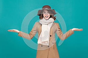Amazement woman dressed in coat, hat and scarf.