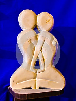 Amazigh white stone statue sculpture of love, with a blue silk background