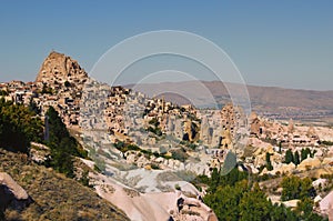 Amazing aerial landscape view of ancient Ortahisar cave city. Blue sky background. Popular travel destination in Turkey