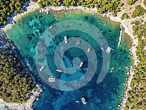 Aerial photo of boats moored at beautiful Velo Borce beach on Hvar island in Croatia photo
