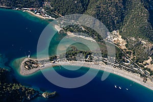 Amazing aerial view of Blue Lagoon in beach resort in the Fethiye district - Oludeniz.  Turkey. Summer landscape with mountains, g