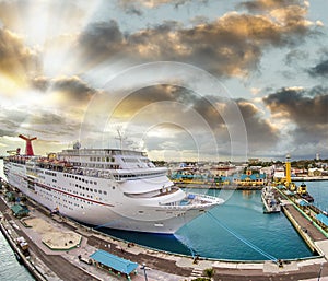 Amazing aerial view of cruise ship docked in a caribbean port at sunset. Vacation and relax concept