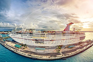 Amazing aerial view of cruise ship docked in a caribbean port at sunset. Vacation and relax concept