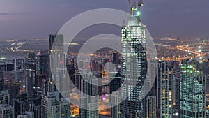 Amazing aerial view of Dubai downtown skyscrapers night to day timelapse, Dubai, United Arab Emirates