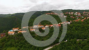 Amazing aerial view of Sighnaghi town and mountains in Georgia, green landscape