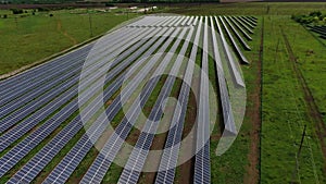 Amazing aerial view on a solar power station with long rows of solar panels, 4k