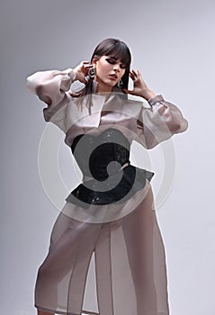 Amazing asian beautiful woman with bob stright black hair style posing in fashion silk clothing on gray background. Closeup