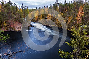 Amazing autumn landscape with blue river and yellow forest, Oulanka National park, Finland
