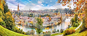 Amazing autumn view of Bern city on Aare river during evening with Pont de Nydegg bridge , cathedral of Bern and Nydeggkirche -