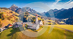 Amazing autumn view from flying drone of Dlijia Da Curt Catholic church, photo