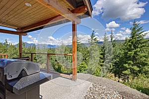 Amazing balcony patio with fire pit and forest and mountains view. Dream come true home exterior. New AMerican architecture.