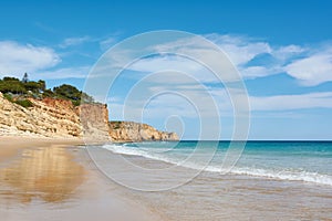 Amazing beach Porto de Mos, Portugal. High cliffs and azure ocean water