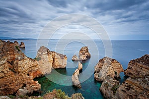 Amazing beach at sunrise. Algarve in the south of Portugal is a travel vacation destination for many tourists. Beautiful cliffs, c