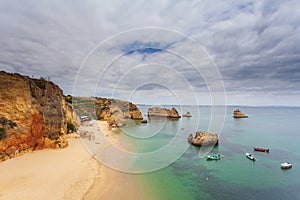 Amazing beach at sunrise. Algarve in the south of Portugal is a travel vacation destination for many tourists. Beautiful cliffs, c