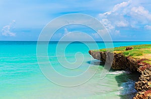 Amazing beautiful landscape view on tranquil turquoise ocean and cliff with blue cloudy sky background